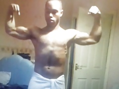 Black muscle flexing wearing a towel