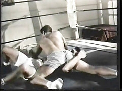 Guys with great bodies are having a wrestling game at the gym