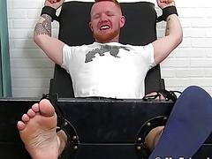 Bearded stud with red hair restrained for naughty tickling domination