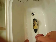 Pissing into wife's black pumps at a hotel room tub