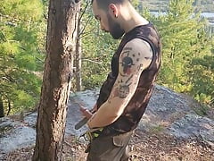 Hairy tattooed stud blowing a load in the woods