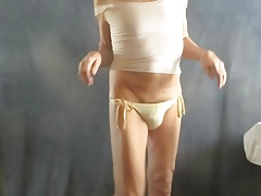 Panty sissy models his string bikini.