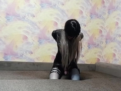A crossdresser roped in an armbinder and ball-gagged, incapable to unwind the bonds