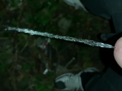 Urinate on the ground outdoor - close up and slow movability - long pee load