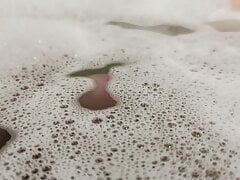 Uncutted cock come up from the foam in the water