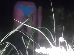 Crossdresser toying in field