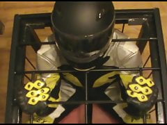 Caged bikerslave in full biker gear