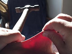 Foreskin in sunlight with hammer