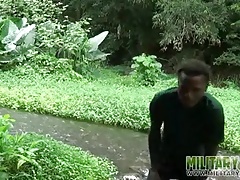 Brown soldier strips naked by the stream