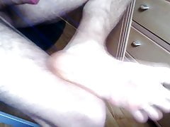 Foot torture with rubber bands and wooden spoon.