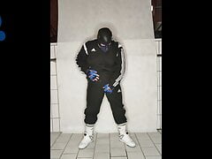 Tracksuit pup pawing off sniffing sneakers