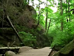 Naked sissy walks through a picturesque canyon