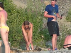 naked blonde undresses and showers in front of group on beach NFCM