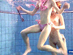 insane girls disrobe eachother in the pool