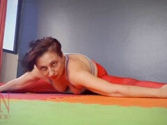 Regina Noir practices yoga in the gym wearing a seductive red yoga leotard