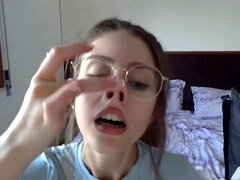 Smiley brunette teen in glasses showing off her petite body solo