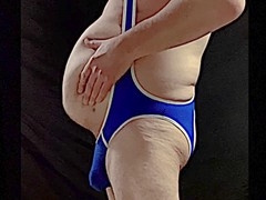 Mature coach with massive belly suits up in a tight singlet and shows off his bulge