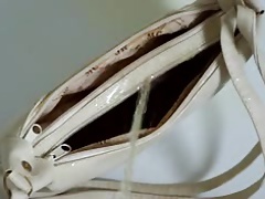 Pee in white leather handbag