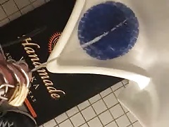 Chastity pissing in a public urinal