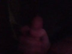 Man in dark plays with big cock