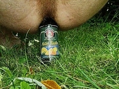 Drilling rump with a bottle outdoors and jizm with strapped sack