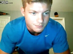 Buff blonde guy grabs his cock to stroke it wildly