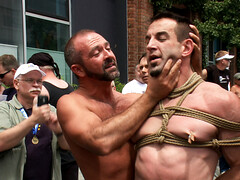 Muscular slave in a hardcore BDSM public bondage play