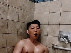 Super-Naughty Chinese school jock plays with faux-cock in risky public douche