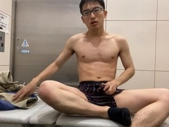 Japanese teenager masturbates naked in public toilet and gets a cumshot