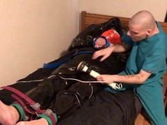 Rubber Boy in Leather Bondage