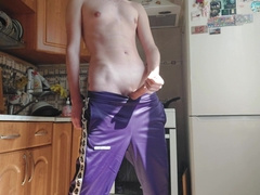 A Russian dude in sweatpants wanks off in the kitchen.