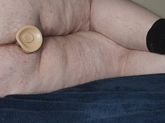 Chub laying down toying with fake penises
