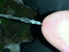 Urinate on the ground outdoor - close up and slow movability - long pee load