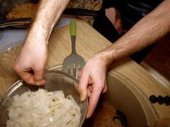 Beautiful cooking. Bare shirtlifter chef is cooking rice noodle with chicken and vegetables