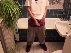 Young man urinating himself