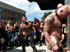 Nick Moretti in a public domination scene with Luke Riley