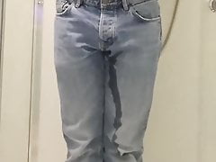 Guy pees in jeans