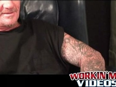 Inked mature guy tugging and stroking his dick solo
