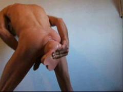 Gay guys stretches out his asshole with a massive dildo