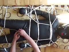 Restrained rubberslave is enjoyed