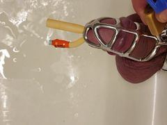 Pissing with catheter locked in chastity cage