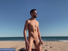 Brazilian hunk strutting naked on public beach drives viewers wild