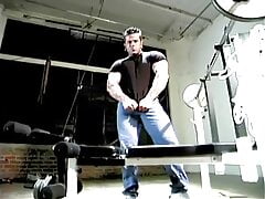 Muscle stud with pierced nipples oiling his body