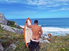 A cheeky surfer getting a prick and urinate from a tourist.