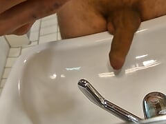 He pisses in the sink with his huge cock