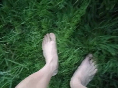 Jon Arteen in brief cutoffs ambles on grass bootless, displays his fellow feet, grins for you