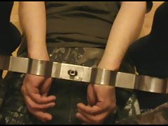 Military slave is hoguffed by rigidcuff.