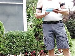 Daddy gardener doing yard work and hosing off