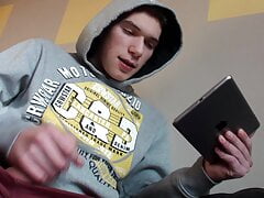 Cute gay guy passes the time with erotic masturbation until he comes to cum