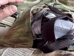 Army soldier strips off boots and reveals a swimsuit under his uniform and jerks off his throbbing cock